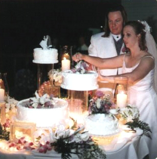 The newlyweds cutting the wedding cake